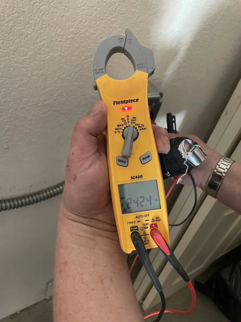 Voltage testing with clamp meter during Ceiling Fan Installation in Iola